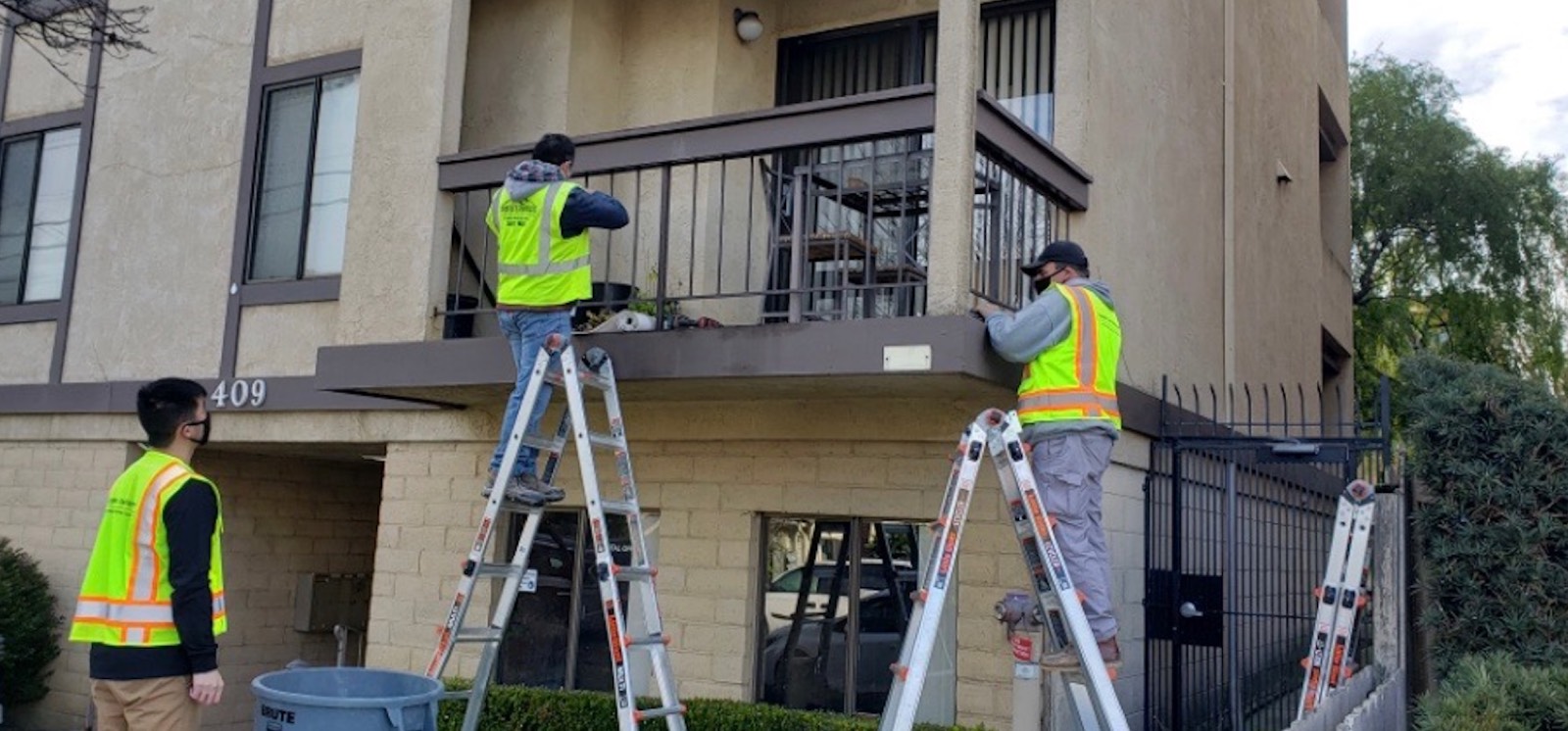 NAXA engineers inspecting balconies and elevated walkways on a multi-family building